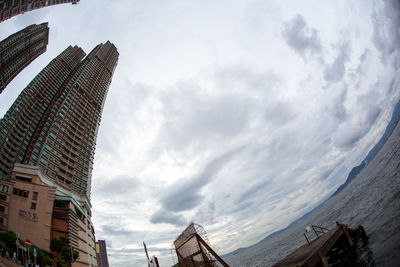 Low angle view of buildings against cloudy sky