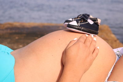 Midsection of woman on beach