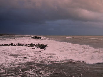 Scenic view of sea against dramatic sky