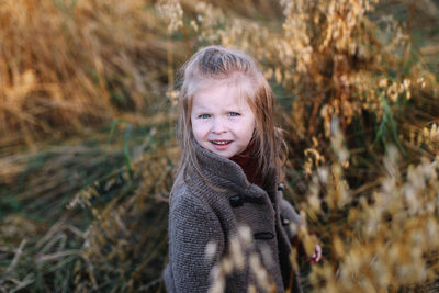 Portrait of smiling girl standing outdoors