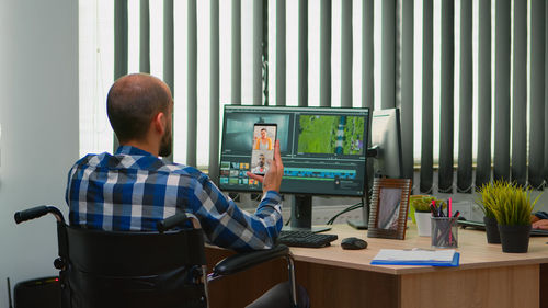 Side view of man working in office
