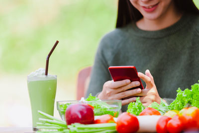 Midsection of man using mobile phone