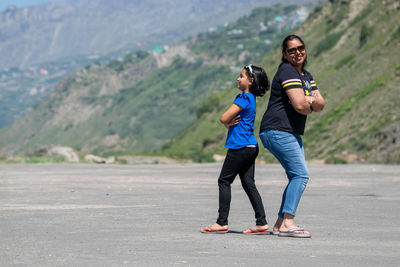 Full length of couple walking on road