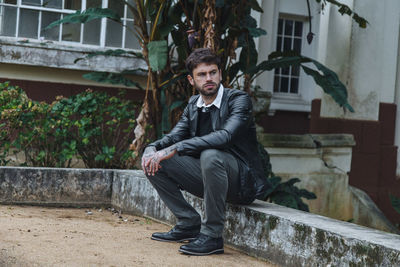 Portrait of young man sitting outdoors