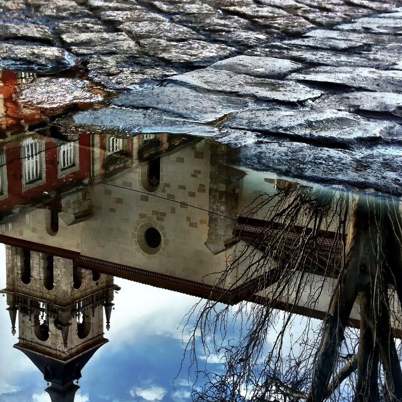 architecture, building exterior, built structure, bare tree, reflection, water, old, building, sky, puddle, outdoors, mode of transport, weather, transportation, canal, day, abandoned, city, tree, low angle view