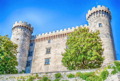Low angle view of historical building against blue sky