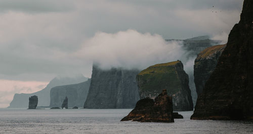 Panoramic view of sea and rocks against sky