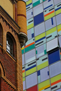 Low angle view of multi colored building against sky