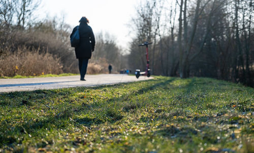 Rear view of man walking on field