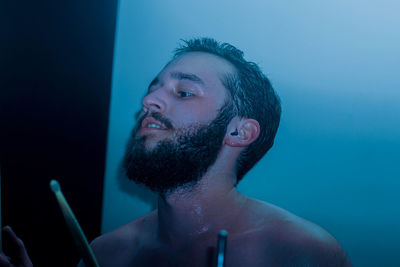 Close-up of shirtless young man in water