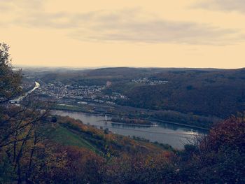 High angle view of river by landscape against sky