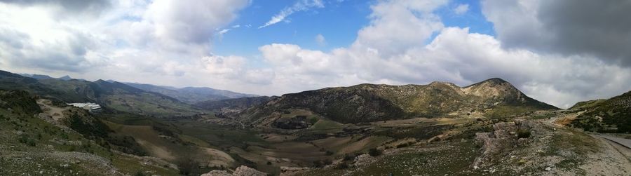 Bratuful landscape of the countryside of guelma, algeria with cloudy sky and green trees and grass