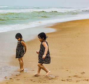 Rear view of people on beach