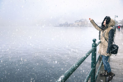 Woman standing on snow covered landscape