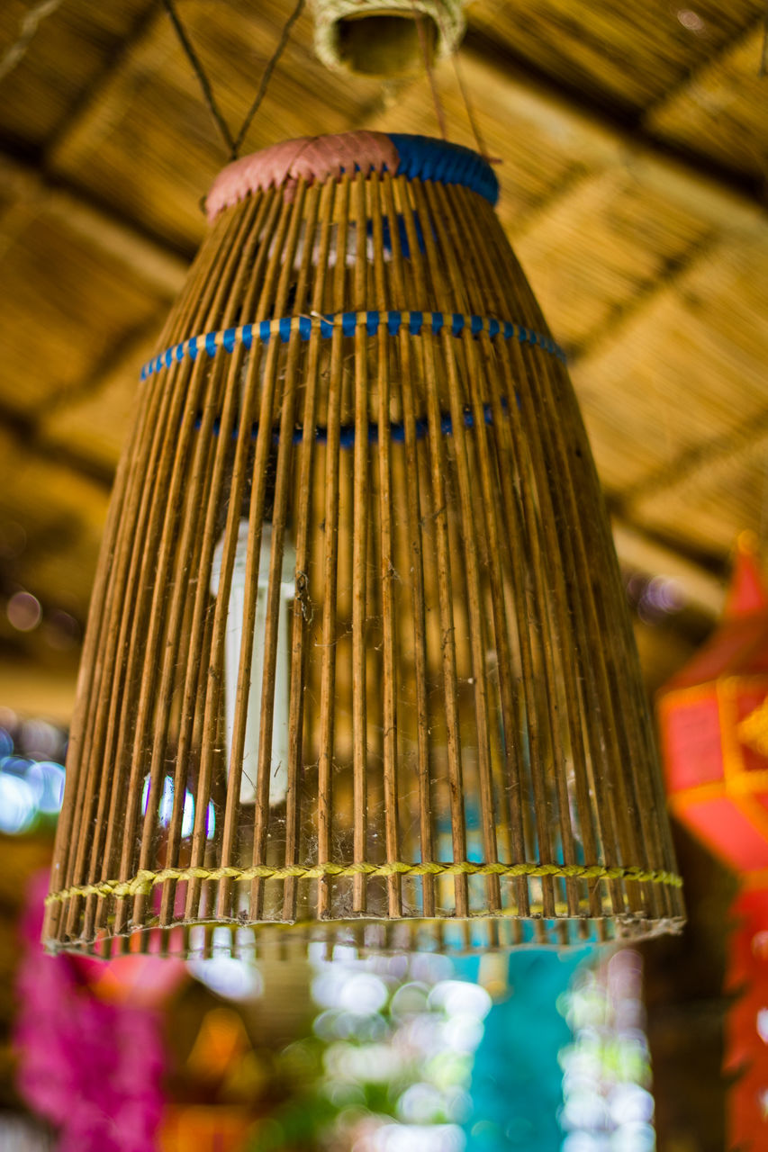 LOW ANGLE VIEW OF UMBRELLAS HANGING ON CEILING