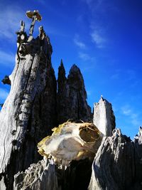 Low angle view of mountain against blue sky