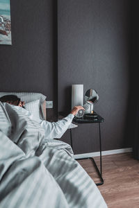 Woman resting on bed at home