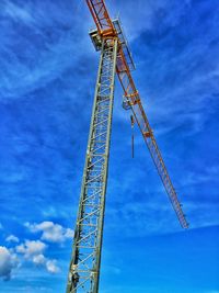 Low angle view of crane against sky