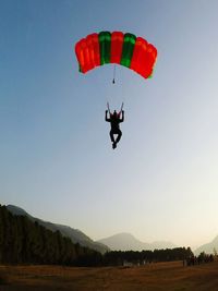 Person paragliding against sky