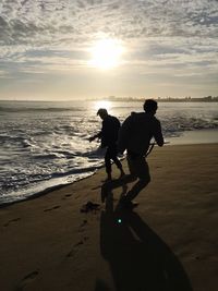 Silhouette of people on beach