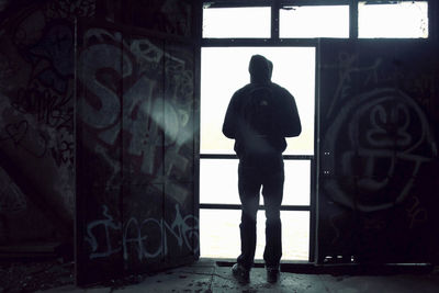 Full length of woman standing by railing