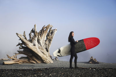 Beautiful, fit surfer girl in the pacific northwest