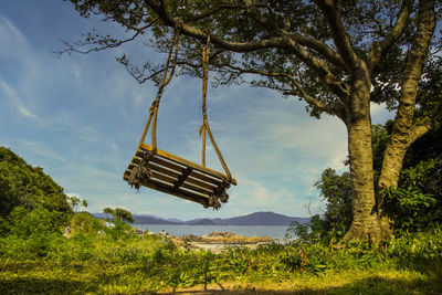 Low angle view of swing against sky