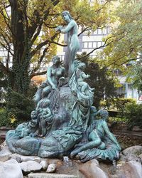 Low angle view of statue against trees