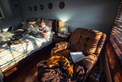 High angle view of people relaxing on bed at home