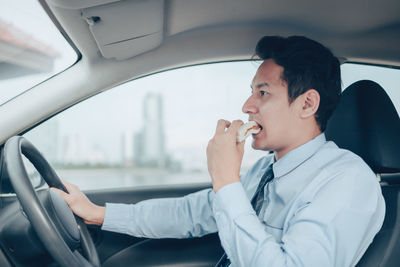 Man using mobile phone in car