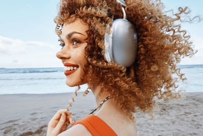 Portrait of young woman looking at beach