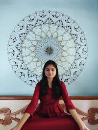 Portrait of young woman sitting outdoors