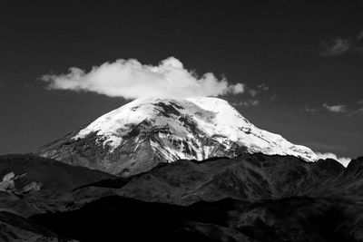 Low angle view of snowcapped mountains against sky