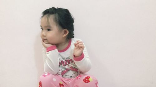 Portrait of cute girl against white background