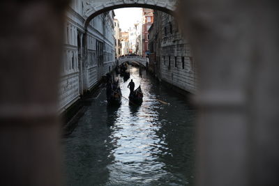 Man on bridge over canal