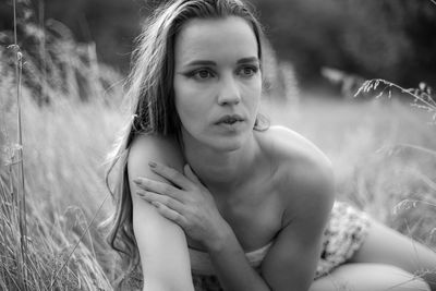 Portrait of beautiful young woman sitting outdoors