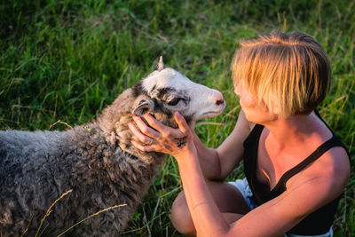 Close-up of woman petting sheep