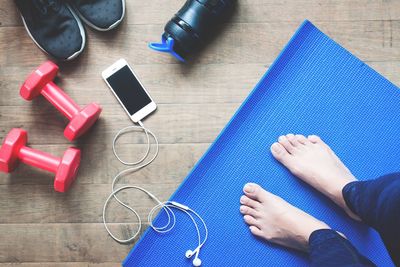 Low section of woman exercising on exercise mat