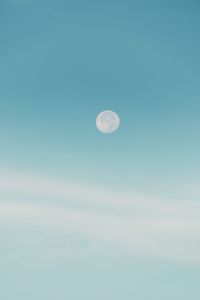 Low angle view of moon against blue sky
