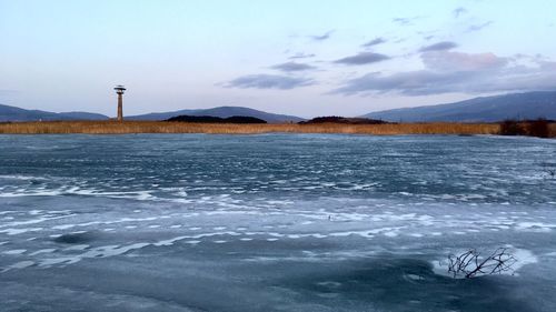 Scenic view of frozen lake against sky