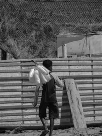 Rear view of man walking on staircase