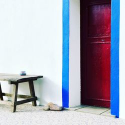 Empty chair on table against building