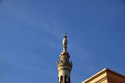 Low angle view of bell tower against blue sky