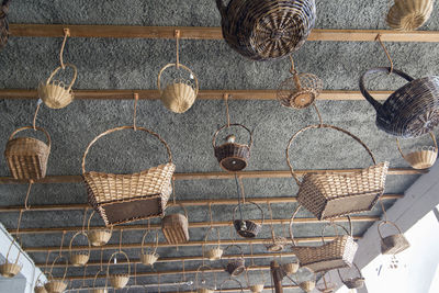 Low angle view of wicker basket hanging against wall