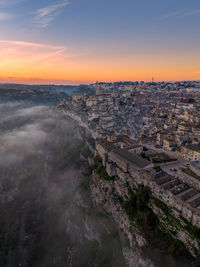 Aerial view of townscape against sky during sunset