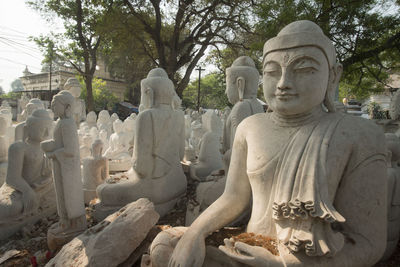Buddha statues against trees