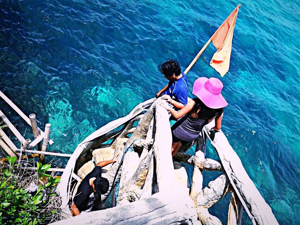 water, nautical vessel, transportation, boat, mode of transport, high angle view, lifestyles, sea, men, oar, leisure activity, travel, moored, blue, rope, rippled, day, fishing