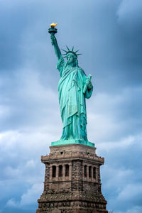 Statue of liberty against cloudy sky