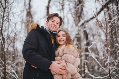 Portrait of couple standing outdoors during winter