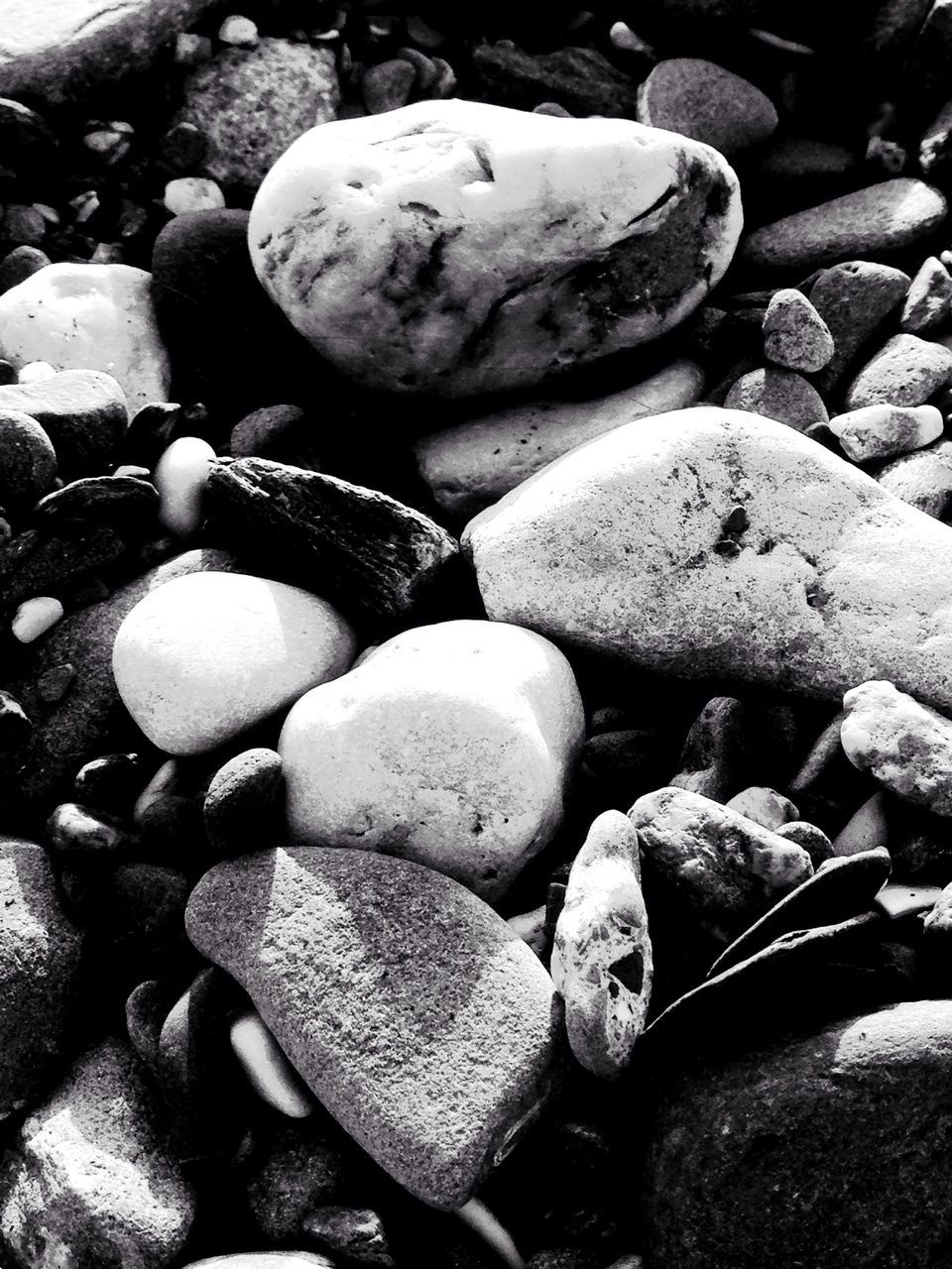 large group of objects, pebble, abundance, stone - object, stack, rock - object, beach, stone, nature, heap, tranquility, textured, shore, no people, outdoors, backgrounds, day, log, close-up, balance